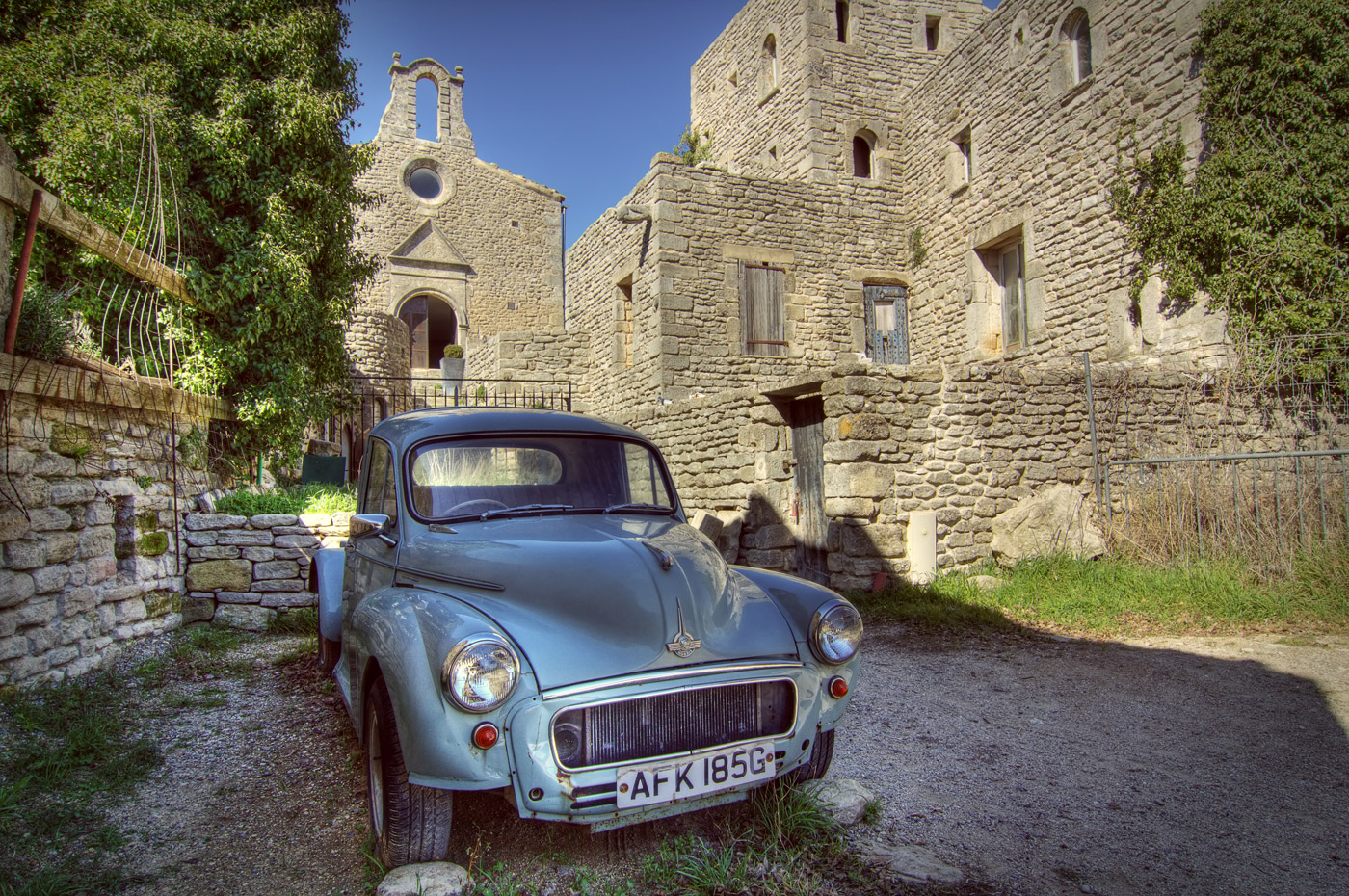Vintage Morris in Saignon. The Chapelle Saint-Michel in the background, Rocher de Saignon. Luberon.